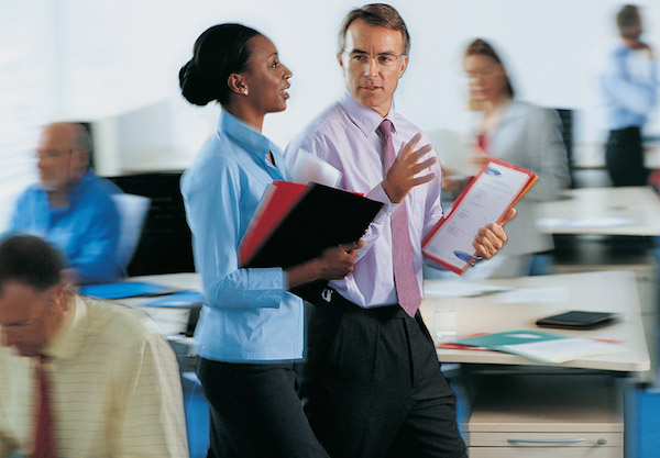 Lady with binders talking to a man