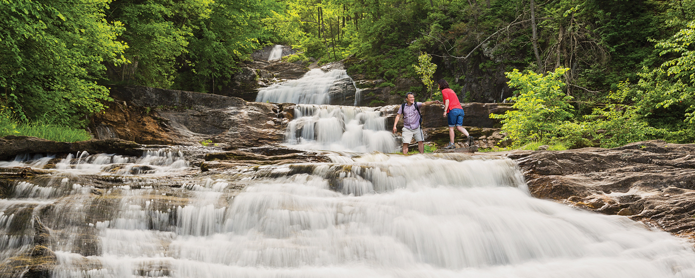 Couple hiking by a waterfall