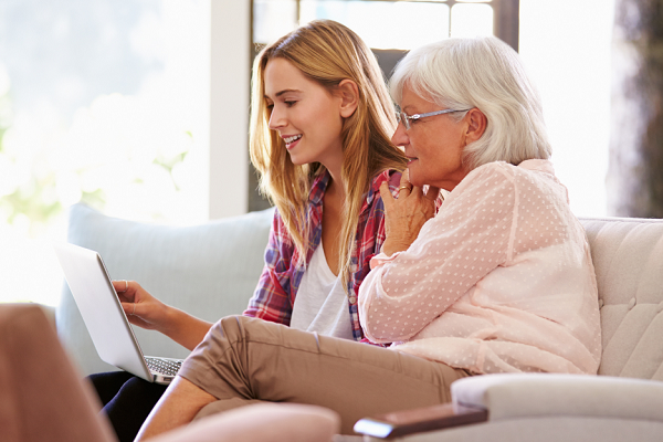 Daughter helping mother find online insurance resources