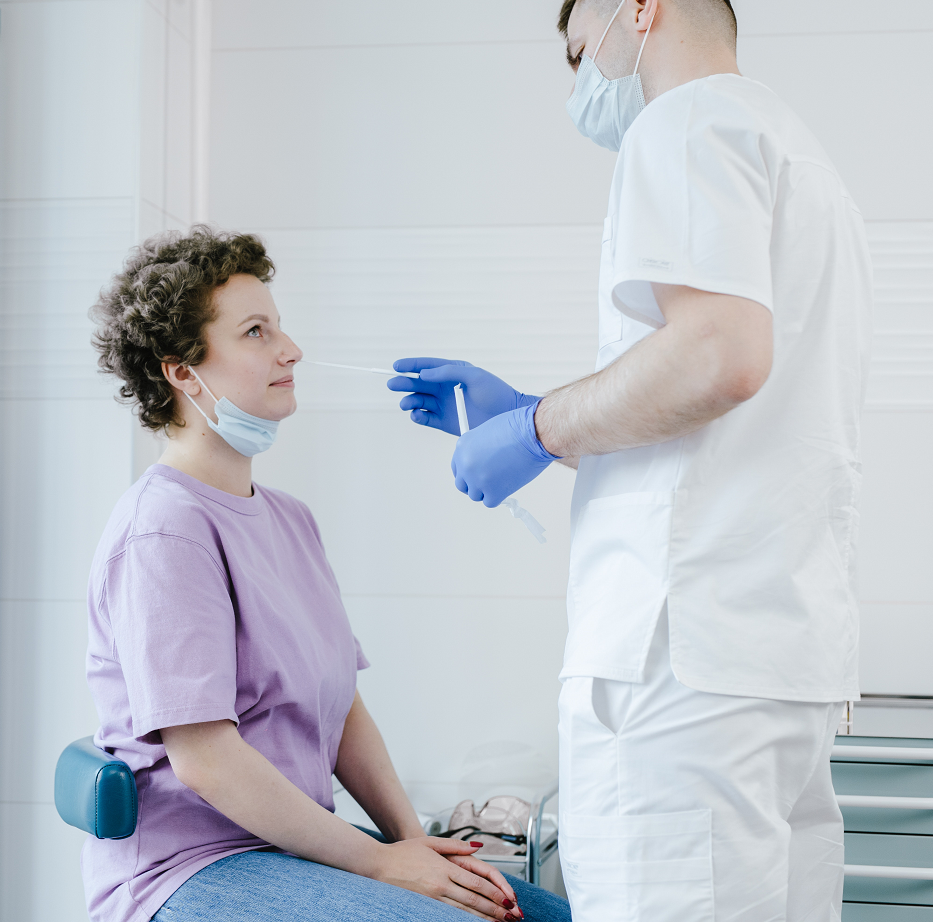 Woman with short hair in CT gets tested with nasal swab during COVID-19