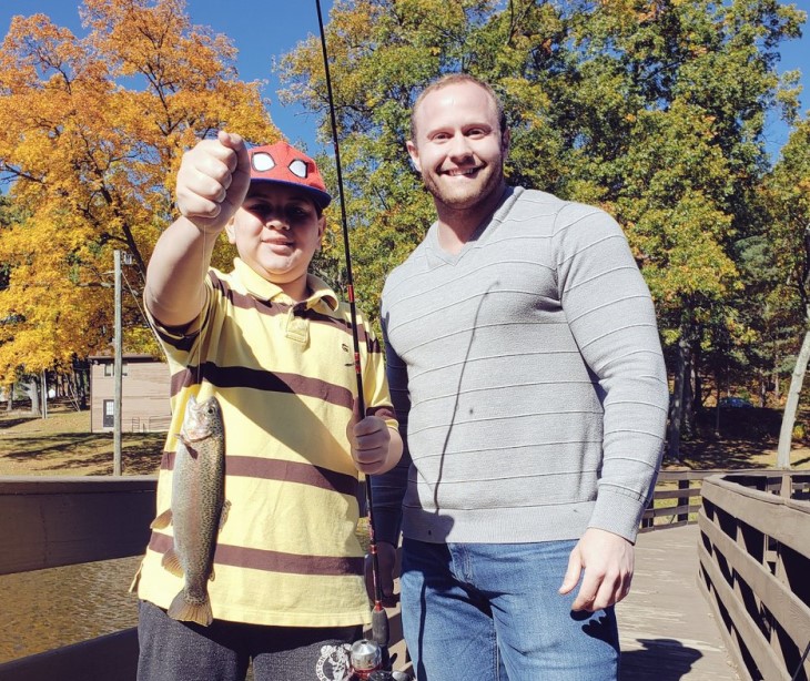 Anglers with a freshly caught rainbow trout.