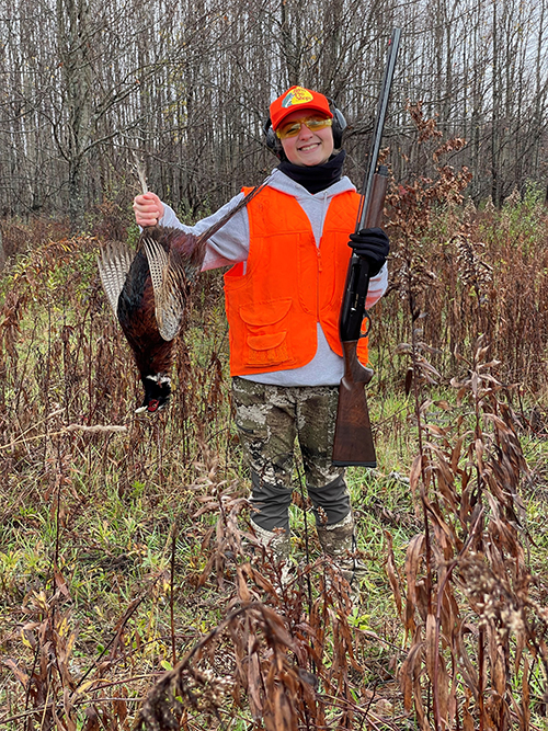 Junior pheasant hunter with a pheasant.