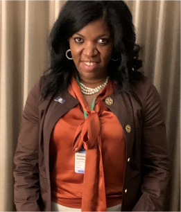 Commissioner Dorantes in an orange shirt with a brown cardigan