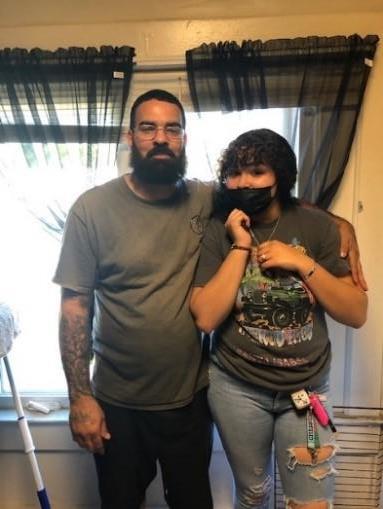 Proud father Christopher stands with his daughter Christinaly