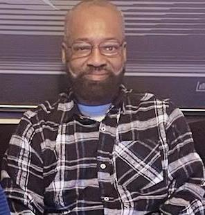 Willie sits and smiles at the camera.  He looks very happy.