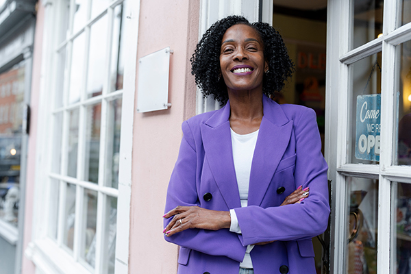 Business owner in front of building.