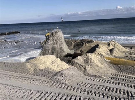 Pile of dredged sand on a beach