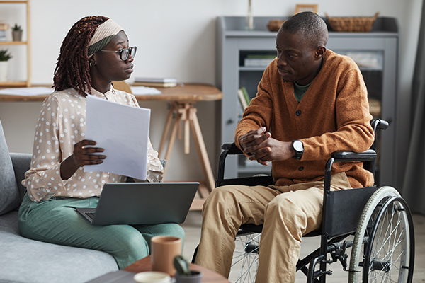 social worker with man in wheelchair
