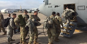 Members of the Connecticut National Guard board a cargo plane