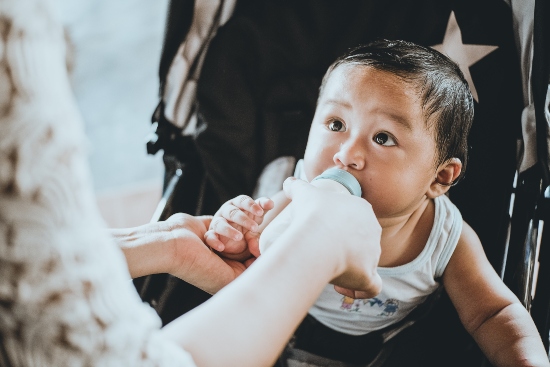 Child feeding on milk during COVID pandemic.