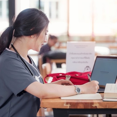 Nurse sitting at a desk and studying.