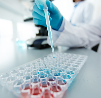 person in lab using test tubes