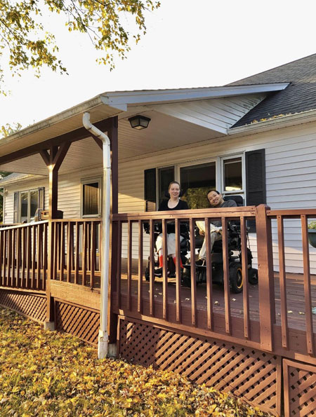 Kellie and Ben on the porch of their new home