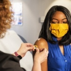 Woman receiving a COVID vaccine.