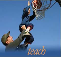 A father helping his child score a basket.