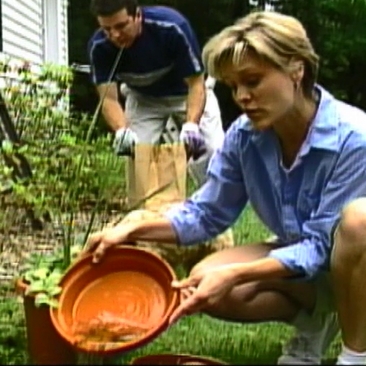 Woman emptying water from container