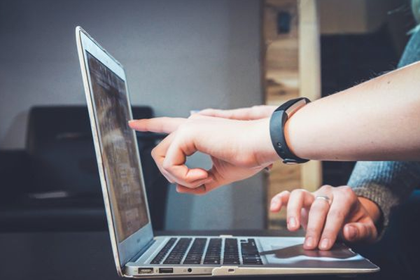 Two people using a laptop computer