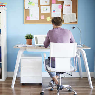 A man sitting at a desk in his home office
